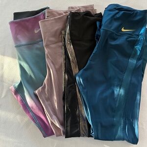 Nike Women's bundle of 4 leggings (3 size Medium Tall, 1 regular Medium)